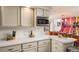 Bright kitchen featuring stainless steel appliances and connected dining room at 7039 Otis Ct, Arvada, CO 80003
