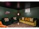 Cozy living room with plush seating, a patterned rug, and neon art at 7039 Otis Ct, Arvada, CO 80003