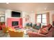 Bright living room with decorative fireplace and cozy velvet seating at 7039 Otis Ct, Arvada, CO 80003