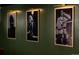 Black and white portraits hang on a deep green paneled wall at 7039 Otis Ct, Arvada, CO 80003