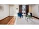 Bright living room featuring hardwood floors and blue armchairs at 1663 S Yampa Way, Aurora, CO 80017