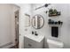 Modern bathroom with floating vanity and round mirror at 17111 E Stanford Ave # C, Aurora, CO 80015