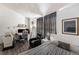 Multipurpose bedroom with a bed, desk, and seating at 17111 E Stanford Ave # C, Aurora, CO 80015