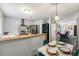 Open concept dining area with view into the living room and kitchen at 17111 E Stanford Ave # C, Aurora, CO 80015