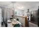 Kitchen with a dining area, green velvet chairs, and a modern light fixture at 17111 E Stanford Ave # C, Aurora, CO 80015