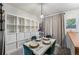 Bright dining area with white table and green chairs, next to built-in shelving at 17111 E Stanford Ave # C, Aurora, CO 80015