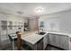Modern kitchen with white cabinets and wood counter, open to the dining area at 17111 E Stanford Ave # C, Aurora, CO 80015