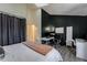 Main bedroom with a king bed, workspace, and access to the bathroom at 17111 E Stanford Ave # C, Aurora, CO 80015