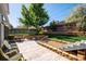 Large backyard featuring patio, lush lawn, and mature trees at 6995 S Kendall Blvd, Littleton, CO 80128