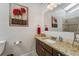 Bathroom featuring a sink with granite countertops and a decorative mirror with vanity lights at 6995 S Kendall Blvd, Littleton, CO 80128