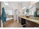 Bathroom featuring a soaking tub, double vanity sinks, and a skylight at 6995 S Kendall Blvd, Littleton, CO 80128