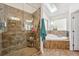 Bathroom with a walk-in shower and a luxurious soaking tub at 6995 S Kendall Blvd, Littleton, CO 80128