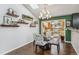 Cozy dining area with hardwood floors, chandelier, and unique architectural details at 6995 S Kendall Blvd, Littleton, CO 80128