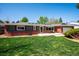 Exterior shot of house featuring well-maintained lawn and porch at 6995 S Kendall Blvd, Littleton, CO 80128