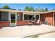 Charming front porch with seating area and brick accents at 6995 S Kendall Blvd, Littleton, CO 80128