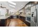 Spacious kitchen with dark wood cabinets, stainless appliances, and ample counter space at 6995 S Kendall Blvd, Littleton, CO 80128