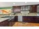 Modern kitchen with granite counters, stainless appliances, and ample cabinet storage at 6995 S Kendall Blvd, Littleton, CO 80128