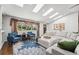 Bright living room featuring skylights, hardwood floors, and stylish decor at 6995 S Kendall Blvd, Littleton, CO 80128