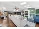 Bright living room with a comfortable sectional sofa, hardwood floors, and abundant natural light from multiple skylights at 6995 S Kendall Blvd, Littleton, CO 80128