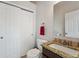 Powder room featuring a granite countertop and a tiled backsplash at 6995 S Kendall Blvd, Littleton, CO 80128