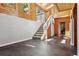 Sunroom featuring a staircase with white railing and entry to a room or office at 6995 S Kendall Blvd, Littleton, CO 80128