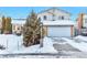 Two-story house with attached garage, snow-covered yard, and mature evergreen tree at 2325 15Th Ave, Longmont, CO 80503
