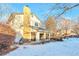 Back exterior view of house with deck and snowy yard at 2325 15Th Ave, Longmont, CO 80503