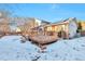 Back exterior of house with deck and snowy yard at 2325 15Th Ave, Longmont, CO 80503