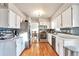 Modern kitchen with stainless steel appliances, white cabinets, and hardwood floors at 2325 15Th Ave, Longmont, CO 80503