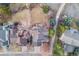Aerial view of the home and backyard with a paved walkway and mature trees, surrounded by neighborhood homes at 2226 Weatherstone Cir, Highlands Ranch, CO 80126