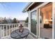 Balcony with table overlooks neighborhood and opens into the sunny and bright main bedroom at 2226 Weatherstone Cir, Highlands Ranch, CO 80126