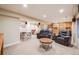 Spacious basement with comfortable seating, built-in shelves, and ample lighting for relaxation and leisure at 2226 Weatherstone Cir, Highlands Ranch, CO 80126