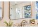 Stylish bathroom vanity with granite countertop, modern fixtures, and a framed mirror reflecting a tiled shower at 2226 Weatherstone Cir, Highlands Ranch, CO 80126