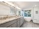 Bright bathroom featuring a double vanity, large soaking tub, and tiled shower with glass door at 2226 Weatherstone Cir, Highlands Ranch, CO 80126
