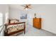 Bright bedroom with wood dresser, decorative metal bed frame, and a large window at 2226 Weatherstone Cir, Highlands Ranch, CO 80126