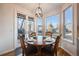 Sun-filled breakfast nook with a round wooden table and backyard views at 2226 Weatherstone Cir, Highlands Ranch, CO 80126