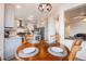 Breakfast nook adjacent to the kitchen with a wooden table and view of the kitchen at 2226 Weatherstone Cir, Highlands Ranch, CO 80126