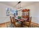 Formal dining room with stylish lighting fixture, hardwood floors, and a large window at 2226 Weatherstone Cir, Highlands Ranch, CO 80126