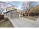 Inviting two-story home with stone accents, attached two car garage, and a well manicured front yard at 2226 Weatherstone Cir, Highlands Ranch, CO 80126