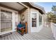 Charming covered front porch featuring a wooden bench with blue cushions and a decorative wreath at 2226 Weatherstone Cir, Highlands Ranch, CO 80126