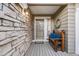 Inviting porch with stone detail and a cozy wooden bench with stylish blue pillows and a decorative wreath at 2226 Weatherstone Cir, Highlands Ranch, CO 80126