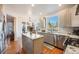 Bright kitchen with stainless steel appliances, granite counters, kitchen island and an eat-in area at 2226 Weatherstone Cir, Highlands Ranch, CO 80126