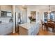 Eat-in kitchen featuring stainless steel appliances, a center island with granite countertop, and updated cabinetry at 2226 Weatherstone Cir, Highlands Ranch, CO 80126