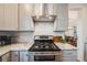 A kitchen area showcasing the stainless steel stove top, and white stone counter tops at 2226 Weatherstone Cir, Highlands Ranch, CO 80126