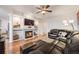 Cozy living room with a fireplace, built-in shelving, and comfortable leather furniture at 2226 Weatherstone Cir, Highlands Ranch, CO 80126