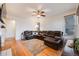 Spacious living room with hardwood floors, a leather sectional, and natural light at 2226 Weatherstone Cir, Highlands Ranch, CO 80126
