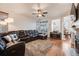 Open living room with hardwood floors, and a large sectional with a view to the breakfast nook at 2226 Weatherstone Cir, Highlands Ranch, CO 80126