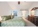 Bright main bedroom with ensuite bathroom featuring sliding barn door, windows, and dark wooden furniture at 2226 Weatherstone Cir, Highlands Ranch, CO 80126