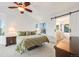 Light filled main bedroom boasts ceiling fan, ensuite bathroom with sliding barn door and large sunny windows at 2226 Weatherstone Cir, Highlands Ranch, CO 80126