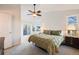 Light filled main bedroom boasts ceiling fan, balcony access, and large sunny windows at 2226 Weatherstone Cir, Highlands Ranch, CO 80126